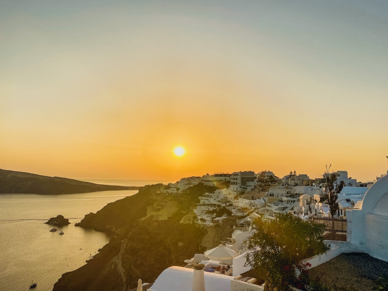 The gorgeous bright orange sunset in Oia Santorini Greece 